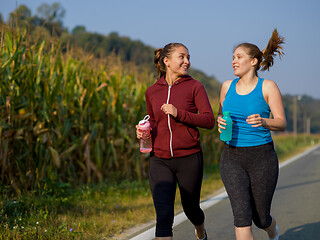 Image showing women jogging along a country road