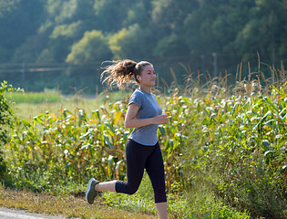 Image showing woman jogging along a country road