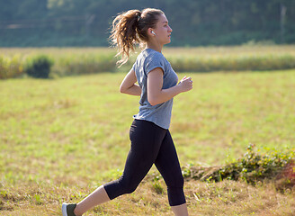 Image showing woman jogging along a country road