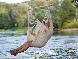 Image showing blonde woman resting on hammock