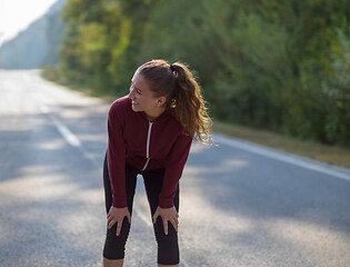 Image showing woman jogging along a country road