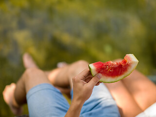 Image showing Couple eating watermelon enjoying picnic time