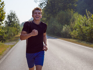 Image showing man jogging along a country road