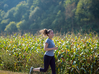 Image showing woman jogging along a country road