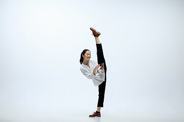 Image showing Woman working at office and jumping isolated on studio background