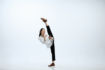 Image showing Woman working at office and jumping isolated on studio background