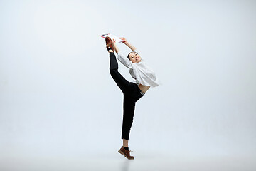 Image showing Woman working at office and jumping isolated on studio background