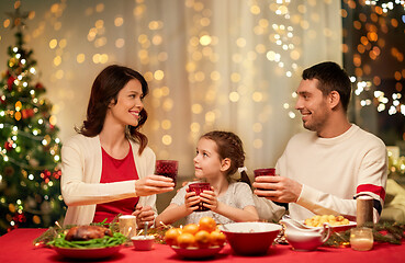 Image showing happy family having christmas dinner at home