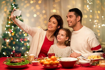 Image showing happy family taking selfie at christmas dinner