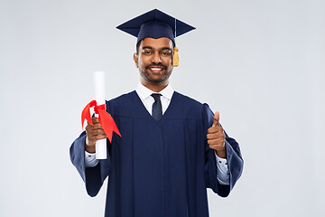 Image showing male graduate student in mortar board with diploma