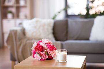 Image showing burning fragrance candle and flower bunch at home