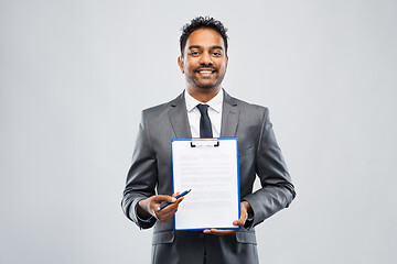 Image showing indian businessman with contract on clipboard