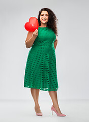 Image showing happy woman holding red heart shaped balloon