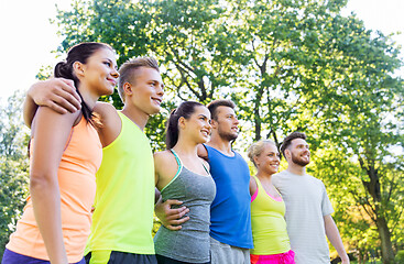 Image showing group of happy friends or sportsmen at summer park