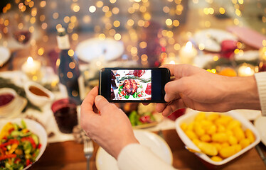 Image showing hands photographing food at christmas dinner