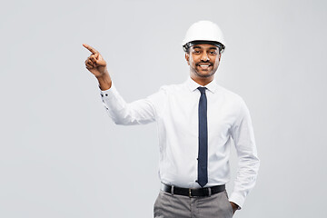 Image showing indian male architect in helmet showing something