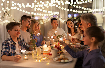 Image showing family with sparklers having dinner party at home