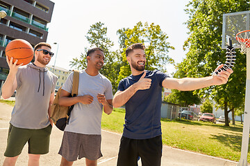 Image showing happy men taking selfie on basketball playground