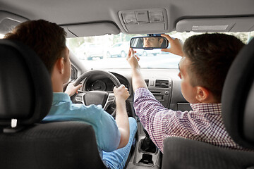 Image showing car driving school instructor teaching man driver