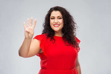 Image showing happy woman in red dress showing four fingers