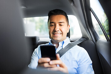 Image showing passenger or businessman using smartphone in car