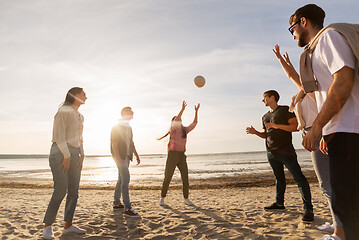 Image showing friends playing volleyball on beach in summer