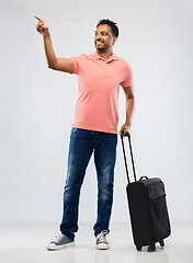 Image showing smiling indian man in polo shirt with travel bag