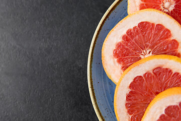 Image showing close up of fresh juicy grapefruits on plate