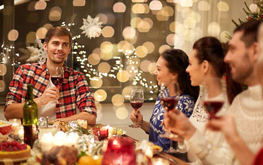 Image showing friends celebrating christmas and speaking toast