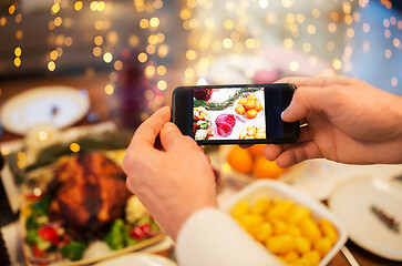 Image showing hands photographing food at christmas dinner