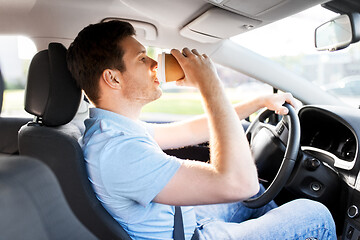 Image showing man or driver driving car and drinking coffee