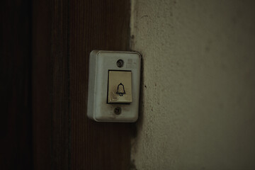 Image showing Old electric door bell fitting on a wooden door