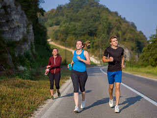 Image showing young people jogging on country road