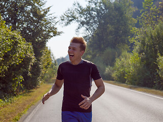 Image showing man jogging along a country road