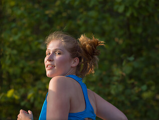 Image showing woman jogging along a country road