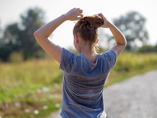 Image showing woman jogging along a country road