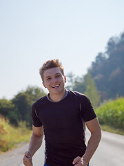 Image showing man jogging along a country road