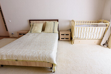 Image showing Bedroom interior, adult bed and newborn\'s bed nearby