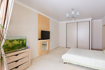 Image showing Interior of a spacious bedroom, stands an aquarium, TV and wardrobe
