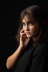 Image showing Beautiful portrait of a young girl on a black background