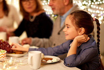 Image showing happy girl having tea party with family at home