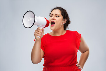 Image showing woman in red dress speaking to megaphone