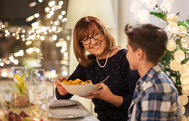 Image showing grandmother and grandson having dinner at home