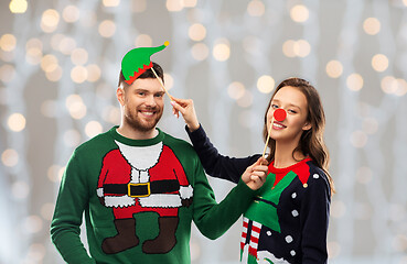 Image showing couple with christmas party props in ugly sweaters