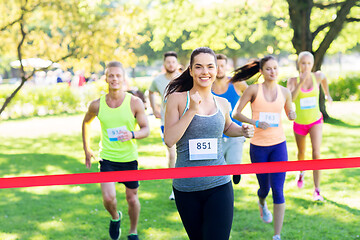 Image showing happy young female runner on finish winning race