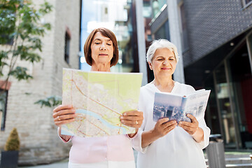 Image showing senior women with city guide and map on street