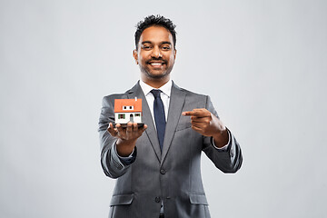 Image showing indian man realtor with house model and folder