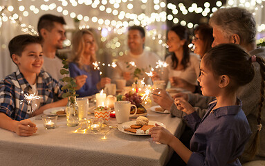 Image showing family with sparklers having dinner party at home