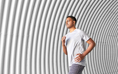 Image showing sporty young man running in tunnel