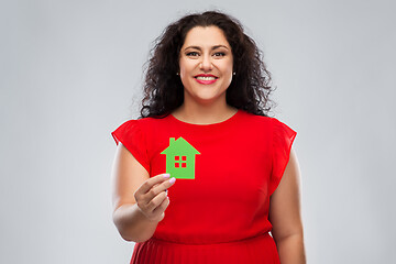 Image showing happy woman in red dress holding green house icon